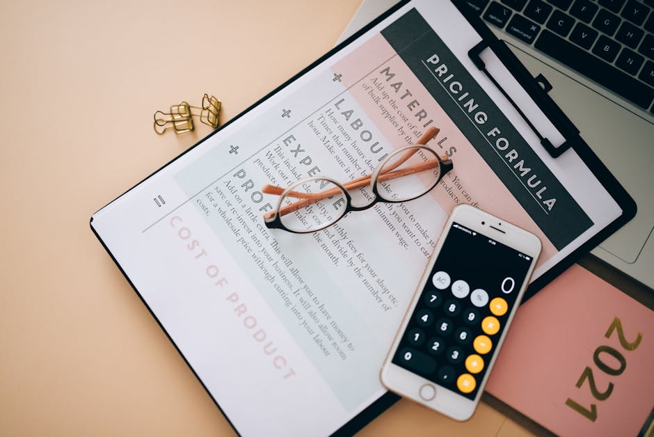 A close-up view of a printed pricing formula document titled 'Pricing Formula,' placed on a light beige desk surface. Resting on the document are a pair of black-rimmed eyeglasses with clear lenses, p
